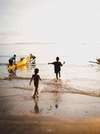 Rear view of men on beach