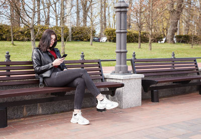 Man sitting on bench in park