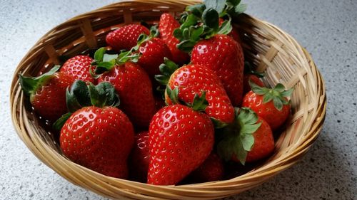 High angle view of strawberries in basket on table