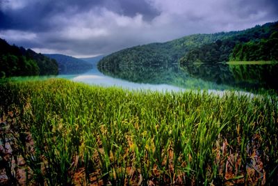 Scenic view of lake against cloudy sky