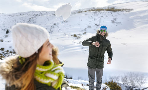 Spain, asturias, couple playing in the snow