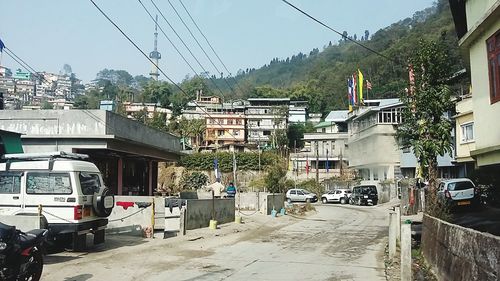 Cars on road against buildings