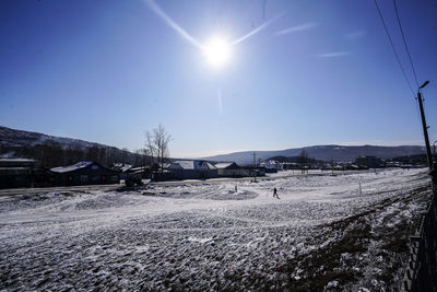 Snow covered landscape against sky