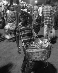 Portrait of boy vendor selling toy at market