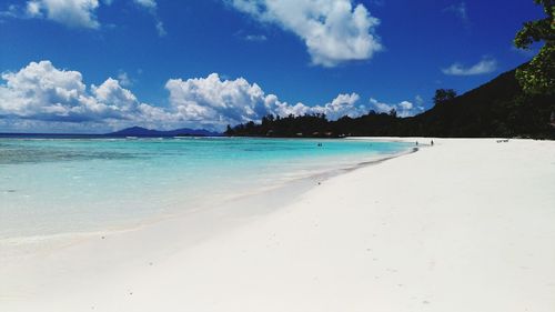 View of beach against cloudy sky