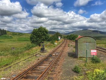 View of railroad tracks against cloudy sky