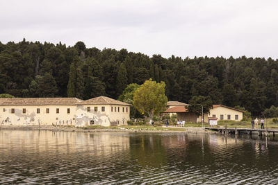 Scenic view of lake by building against sky