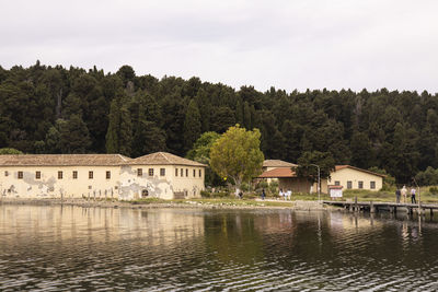 Scenic view of lake by building against sky