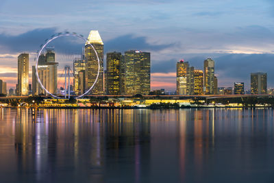 Illuminated buildings in city at waterfront