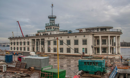 Boats moored at harbor against buildings in city