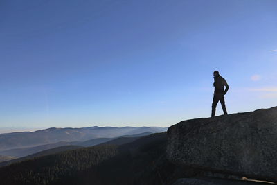 Man standing on mountain against sky