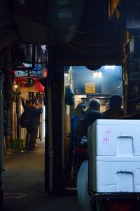 People in illuminated city at night