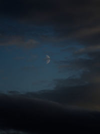 Low angle view of moon in sky at night