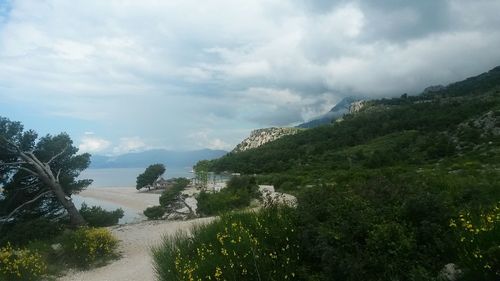 Scenic view of mountains against cloudy sky