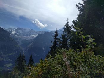 Scenic view of mountains against cloudy sky