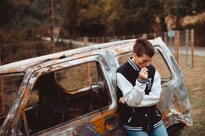 Full length of man standing in car