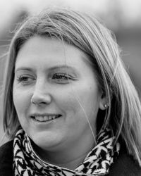 Close-up of smiling woman looking away standing outdoors