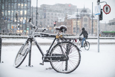 Bicycle parked on snow in city