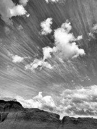 Low angle view of land against cloudy sky