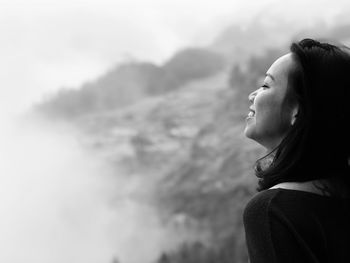 Side view of woman against mountains