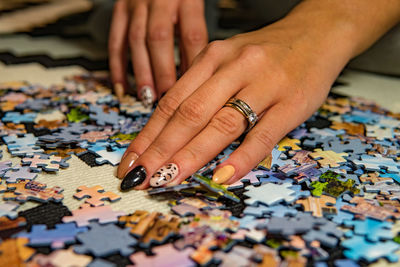 Cropped hand playing with puzzle pieces