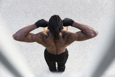 Young man exercising with resistance band