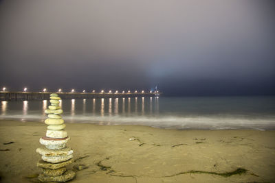 Scenic view of beach against sky at night