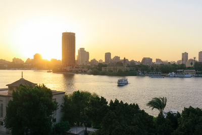 City at waterfront during sunset