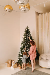 Rear view of woman sitting on sofa at home