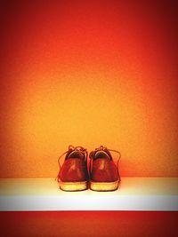 Close-up of red shoes on wall