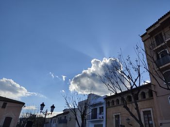 Low angle view of buildings in town against sky