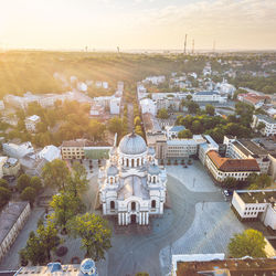 Aerial view of historic church in city during sunset