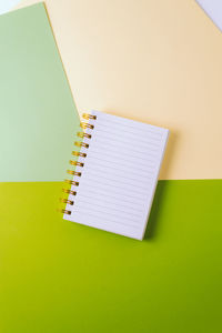 High angle view of book on colored background