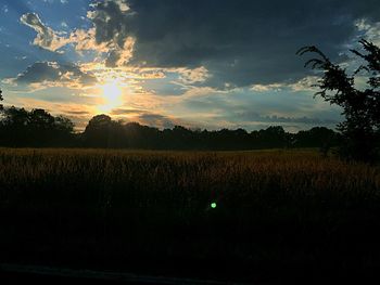Scenic view of field against sky at sunset
