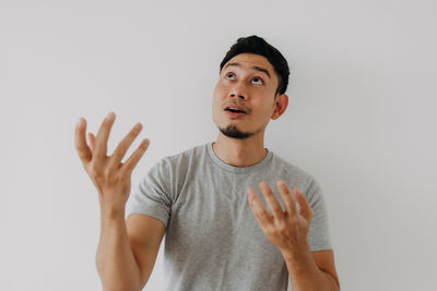 Portrait of young man against white background