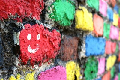 Close-up of smiley face on colorful painted wall