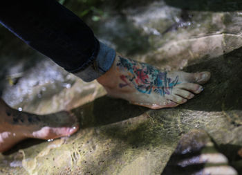 Low section of man legs in water