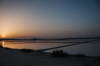Scenic view of sea against clear sky during sunset