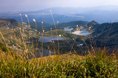 Scenic view of lake by mountains against sky