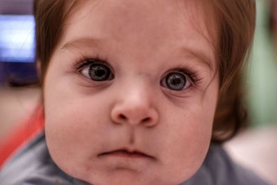 Close-up portrait of cute baby girl at home