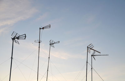 Low angle view of telephone pole against sky during sunset