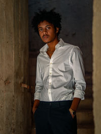 Young man standing against wall