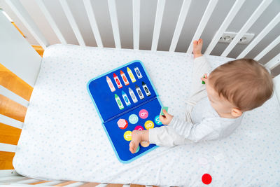 High angle view of cute girl playing with toy blocks on table