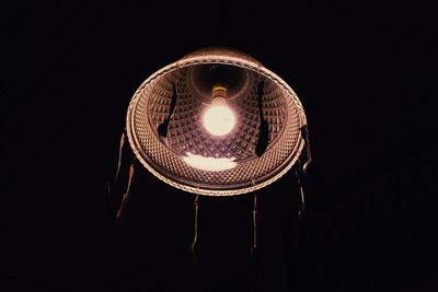 Close-up of illuminated lamp in darkroom