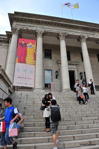 People on staircase of building in city