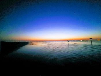 Scenic view of sea against clear blue sky during sunset