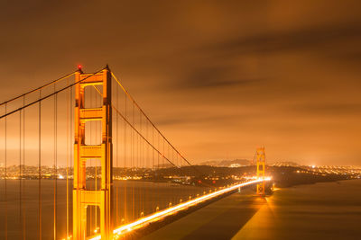 Illuminated suspension bridge at night