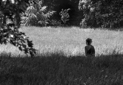 Low angle view of woman sitting on grass