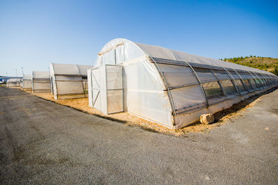 Built structure on land against clear blue sky