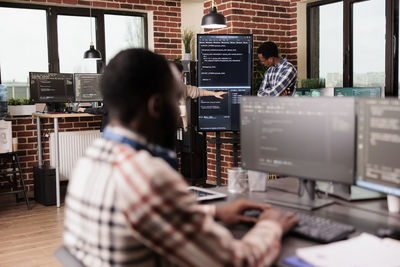 Rear view of man working in office